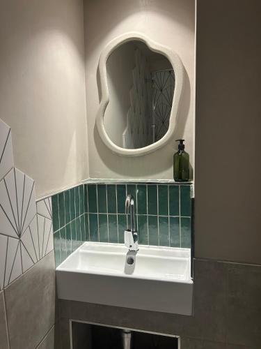 a bathroom with a sink and a mirror at Central and Quirky Northern Quarter Flat, Manchester in Manchester
