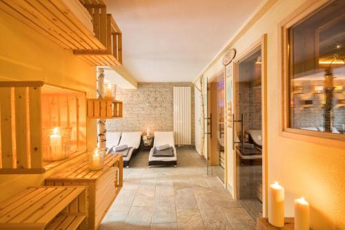 a living room with a couch and chairs and candles at Parkhotel Emstaler Höhe in Bad Emstal