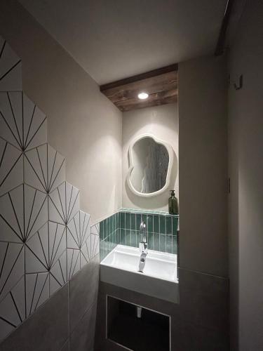 a bathroom with a sink and a mirror at Central and Quirky Northern Quarter Flat, Manchester in Manchester