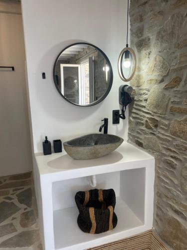 a bathroom with a sink and a mirror at Darsi suites Kythnos in Kithnos