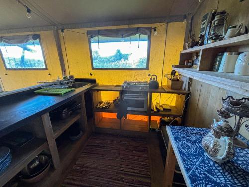 a kitchen with a sink and a stove in it at Golden Grove Retreat Lodge Luna in Carmel