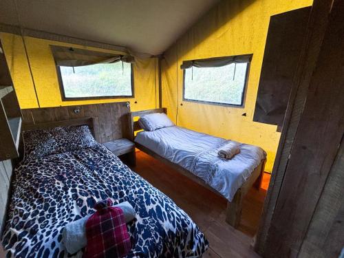 a bedroom with two beds in a small room at Golden Grove Retreat Lodge Luna in Carmel