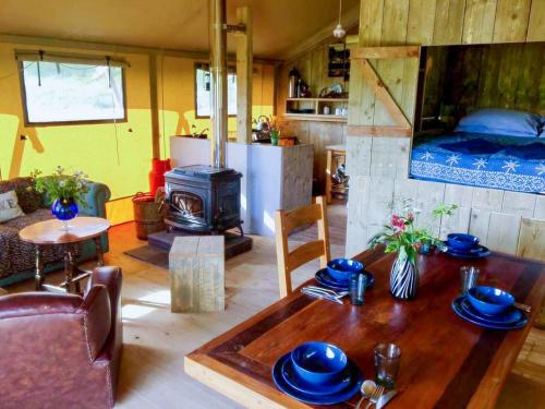 a living room with a table and a stove at Golden Grove Retreat Lodge Luna in Carmel