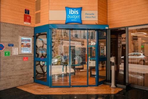 a bus shelter with a sign on the side of a building at ibis budget Marseille Vieux Port in Marseille