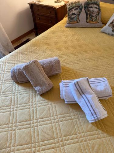 a bed with two towels on top of it at la Bellavita rooms in Caltanissetta