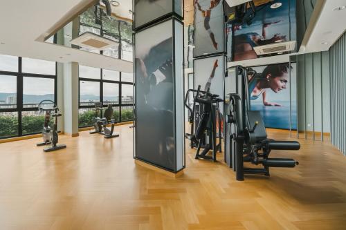 a gym with treadmills and elliptical machines at Ooak Residence in Mont Kiara, Kuala Lumpur in Kuala Lumpur