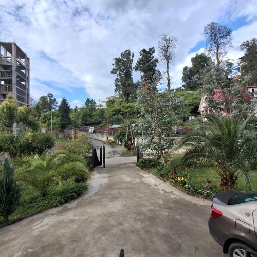 a parking lot with a gate in a park at KEMO house in Batumi