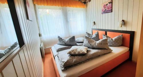a bed with pillows on it in a room at Haus-Dannigkow in Dannigkow