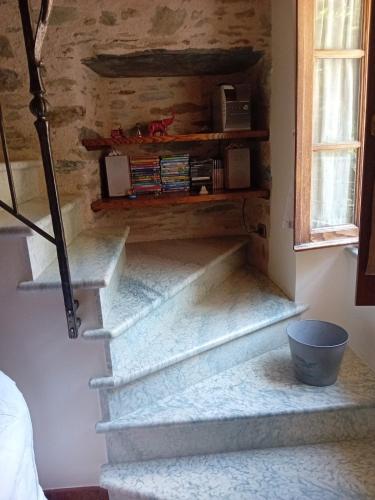 a set of stairs in a room with a window at Casetta sotto il Monte Forato in Stazzema