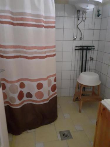 a shower curtain in a bathroom with a stool at Ibolya in Balatonfüred