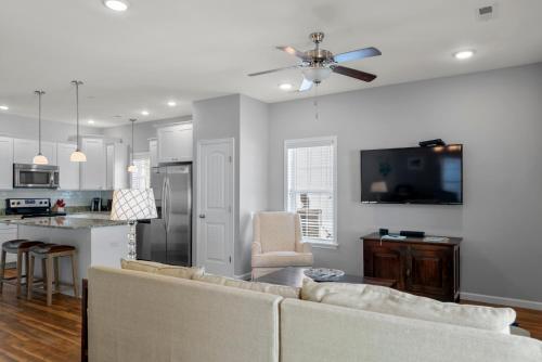 a living room with a couch and a kitchen at The E Gull Has Landed in Kill Devil Hills