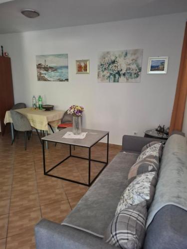 a living room with a couch and a table at Fishing Family House in Čilipi