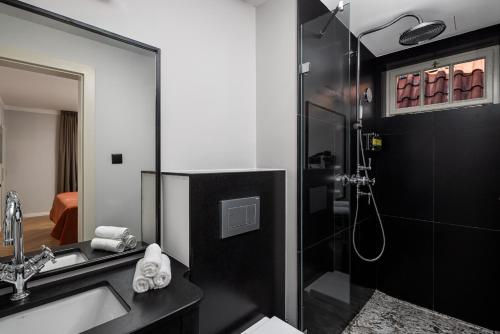 a bathroom with a shower and a sink and a toilet at The Bridge Residence by Little King in Prague