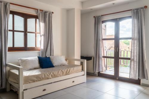 a bedroom with a bed and a large window at Alma departamentos de mar 2 in Ostende