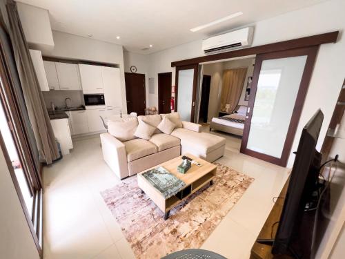 a living room with a couch and a coffee table at Hawana luxury 1BedRoom apartment in Salalah