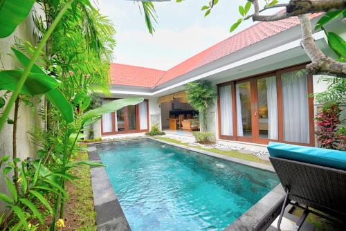 a swimming pool in the backyard of a villa at Villa LAKSMI in Seminyak