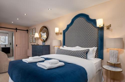 a bedroom with a large bed with towels on it at Munro Guest House in Stirling