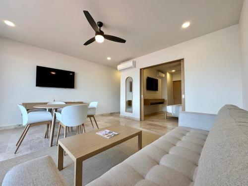 a living room with a couch and a table at abba Suites Playa del Carmen in Playa del Carmen