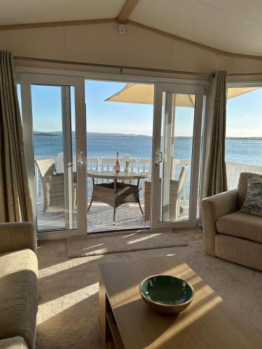 a living room with a view of the ocean at Unobstructed Sea Views , Rockley Park , Poole in Lytchett Minster