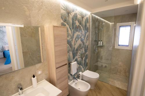 a bathroom with a sink and a toilet and a shower at Casa Vacanze Stella Marina in Marina di Palma