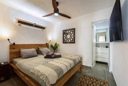 a bedroom with a bed and a flat screen tv at "Sun down" by Corralejobeach Apartments in Corralejo