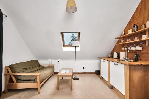 a living room with a couch and a table at Green Gables by Escape Ordinary in Aghnablaney