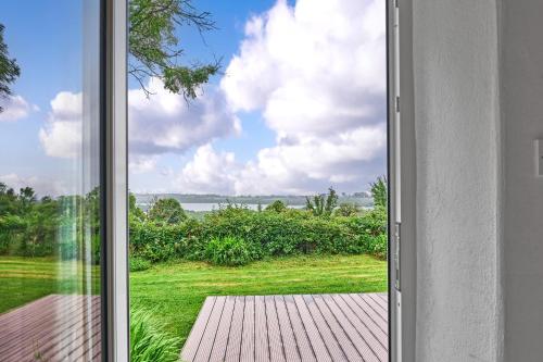 an open door to a patio with a view at Green Gables by Escape Ordinary in Aghnablaney