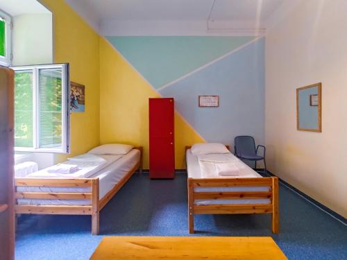 a room with two beds and a staircase at Westend City Hostel in Vienna