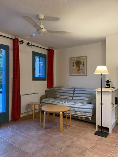 a living room with a couch and a table at MAZET - Domaine de la Pinède PRAMOUSQUIER - Le Lavandou in Le Lavandou