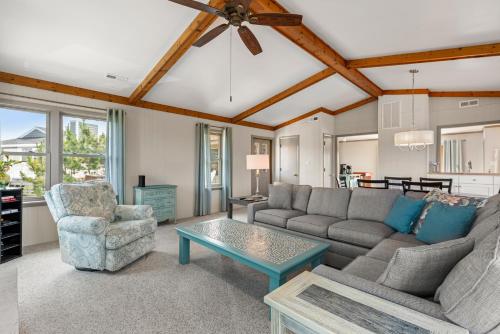 a living room with a couch and a table at The Mayors Nest in Duck