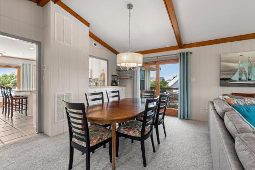 a dining room with a wooden table and chairs at The Mayors Nest in Duck