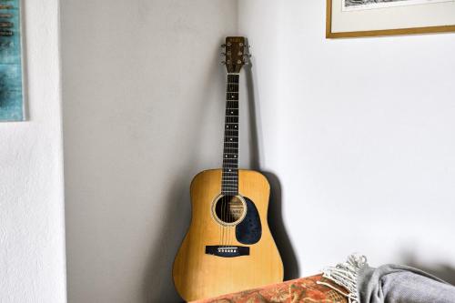 a guitar is hanging on a wall at Green Gables by Escape Ordinary in Aghnablaney