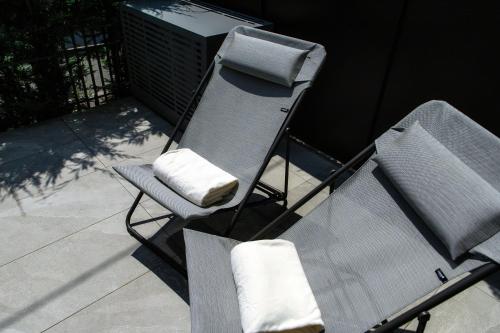 a chair sitting on top of a patio at LA TERRAZZA - Downtown Como - Terrace and Jacuzzi in Como