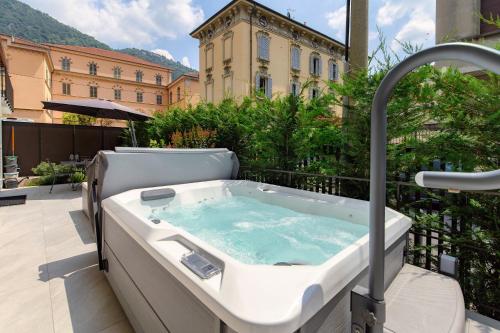 a bath tub sitting on top of a balcony at LA TERRAZZA - Downtown Como - Terrace and Jacuzzi in Como