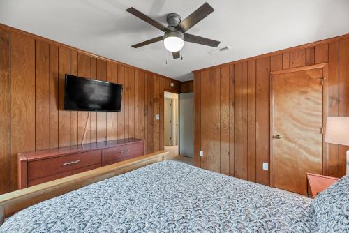 a bedroom with a bed and a flat screen tv at The Mayors Nest in Duck