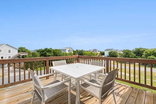 a white table and chairs on a deck at The Mayors Nest in Duck
