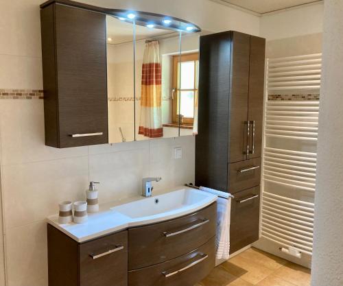 a bathroom with a sink and a mirror at Ferienwohnung Goas-Alm in Waging am See