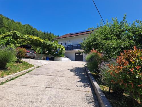 a house with a car parked in front of a driveway at Jakop Hof in Krapinske Toplice
