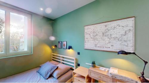a bedroom with a bed and a map on the wall at Jupiter Paris in Champigny-sur-Marne