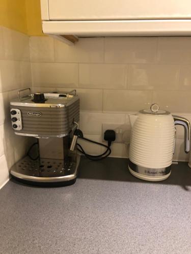 a kitchen counter with a coffee maker and a toaster at Rose Lodge in Saint Albans