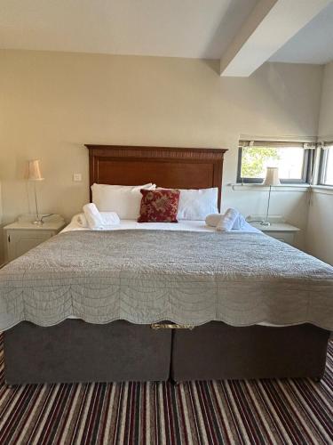 a bedroom with a large bed with two night stands at 11 The Avenue in Killarney