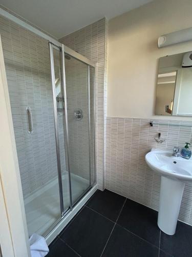 a bathroom with a shower and a sink at 11 The Avenue in Killarney