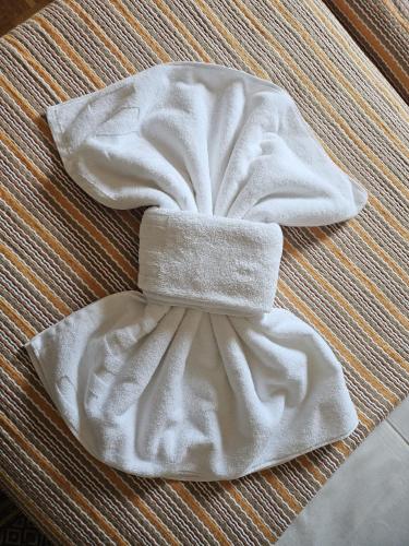 a white bow tie on top of a bed at Casas Sebastião - Tourist House in Caminha