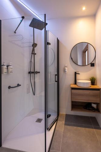 a bathroom with a shower and a sink at White Coast Suites in Alicante