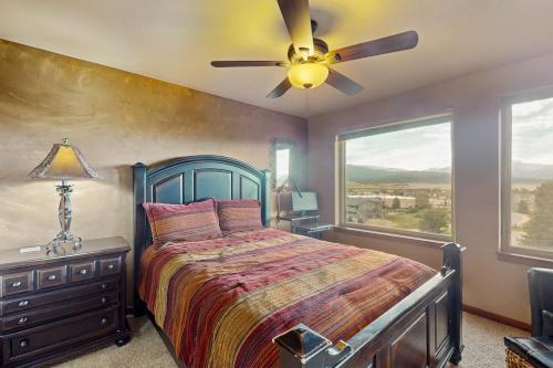 a bedroom with a bed and a ceiling fan at View House in Fraser