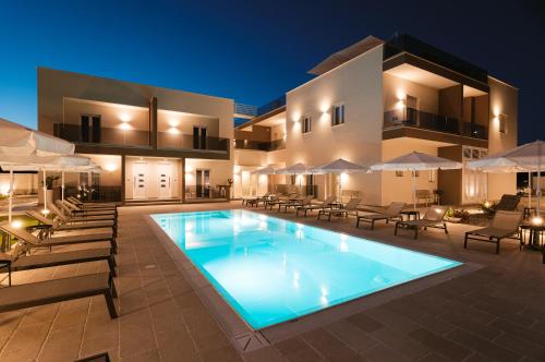 a villa with a swimming pool at night at Eleia Domos in Monopoli