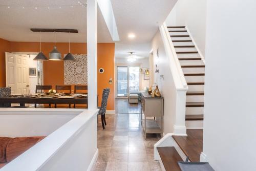 a kitchen and dining room with a staircase in a home at Pet-Friendly Beach Getaway, Relax by the Bay! in Annapolis