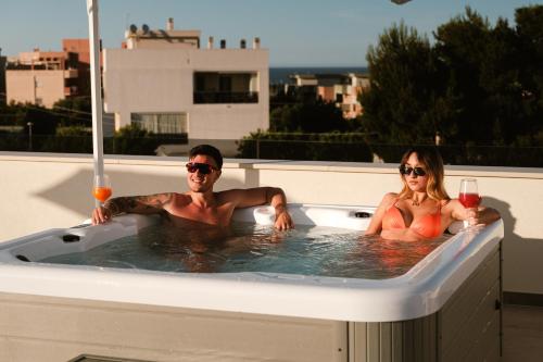 a man and a woman sitting in a hot tub at Eleia Domos in Monopoli