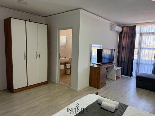 a large living room with a television and a couch at Infinity Plaza Hotel in Gjakove