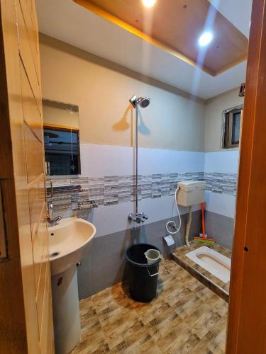 a bathroom with a sink and a shower at HIKK Inn in Skardu